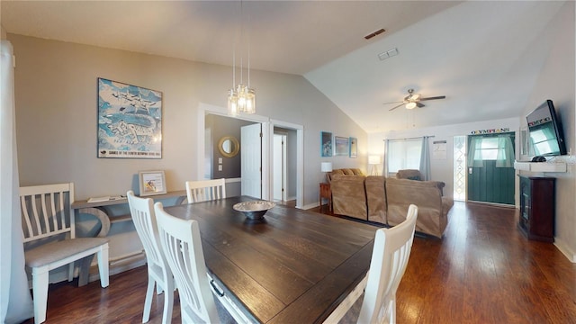 dining room with vaulted ceiling, a ceiling fan, dark wood-type flooring, and visible vents