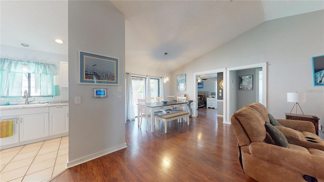 living area with a healthy amount of sunlight, light wood-type flooring, and baseboards