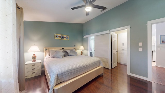 bedroom featuring visible vents, ceiling fan, baseboards, lofted ceiling, and wood finished floors