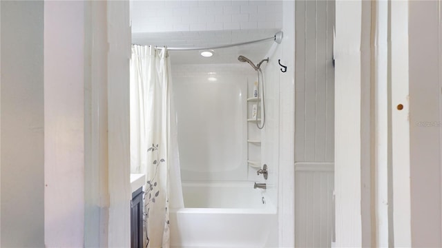 bathroom featuring shower / bath combo with shower curtain and vanity