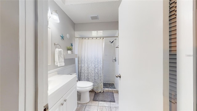 bathroom with vanity, visible vents, a shower stall, a textured ceiling, and toilet