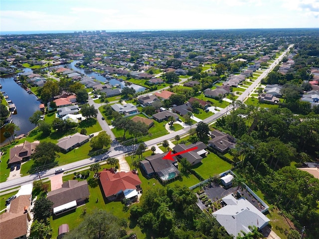 birds eye view of property featuring a residential view and a water view