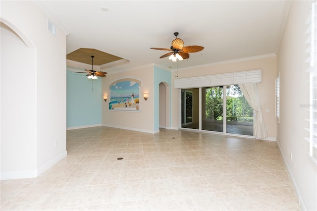 empty room with visible vents, baseboards, ornamental molding, arched walkways, and a ceiling fan