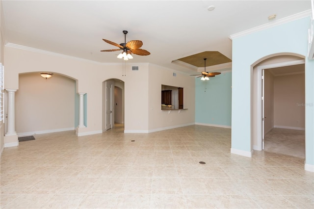 unfurnished living room with baseboards, visible vents, arched walkways, ornamental molding, and ceiling fan