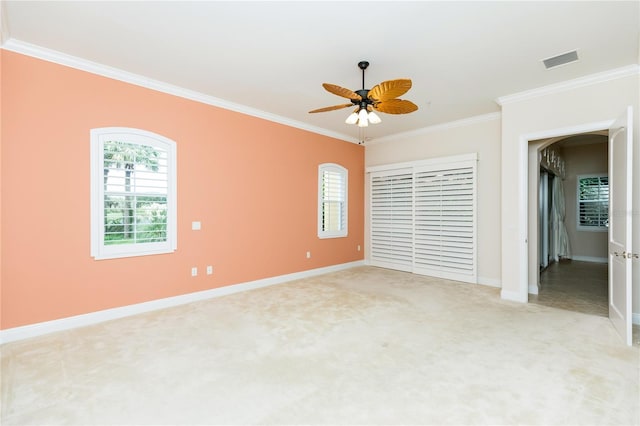 unfurnished bedroom with baseboards, visible vents, ornamental molding, a closet, and light carpet