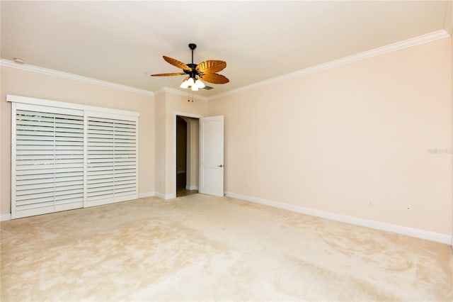 unfurnished bedroom featuring ceiling fan, baseboards, ornamental molding, and carpet flooring