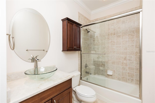 bathroom with vanity, bath / shower combo with glass door, crown molding, and toilet