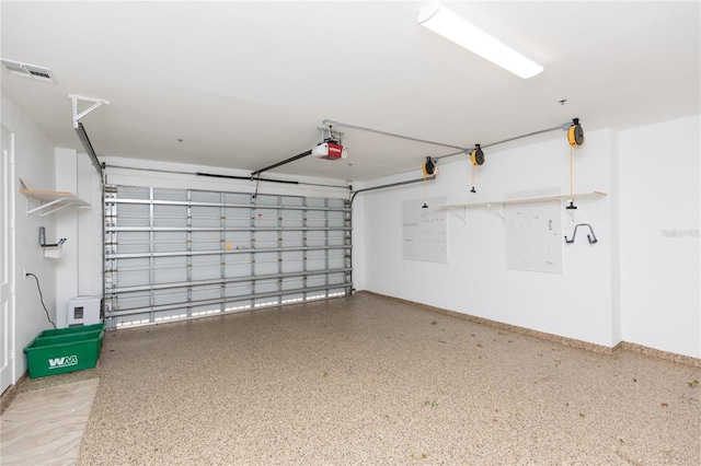 garage featuring visible vents and a garage door opener