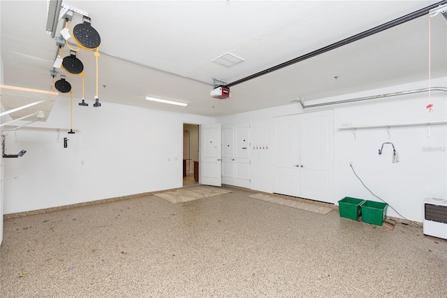 garage with a garage door opener and baseboards