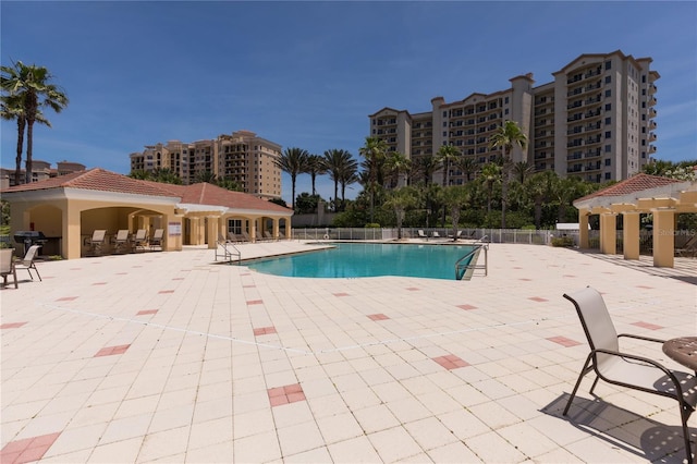 pool featuring a grill, a pergola, a patio, and fence