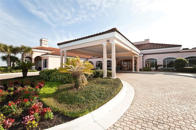 view of building exterior with decorative driveway