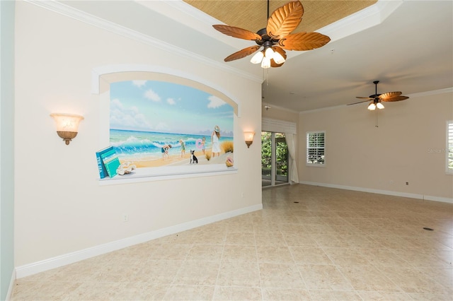 empty room featuring baseboards, a raised ceiling, ceiling fan, and crown molding