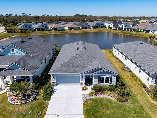 birds eye view of property with a residential view and a water view