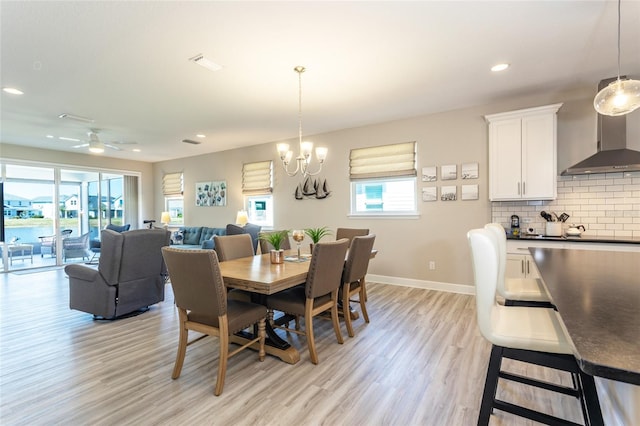 dining area with recessed lighting, light wood-type flooring, baseboards, and ceiling fan with notable chandelier