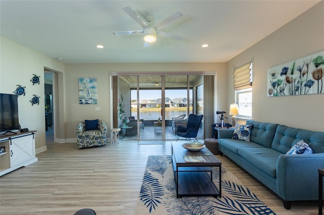 living area featuring recessed lighting, baseboards, light wood-style floors, and a ceiling fan