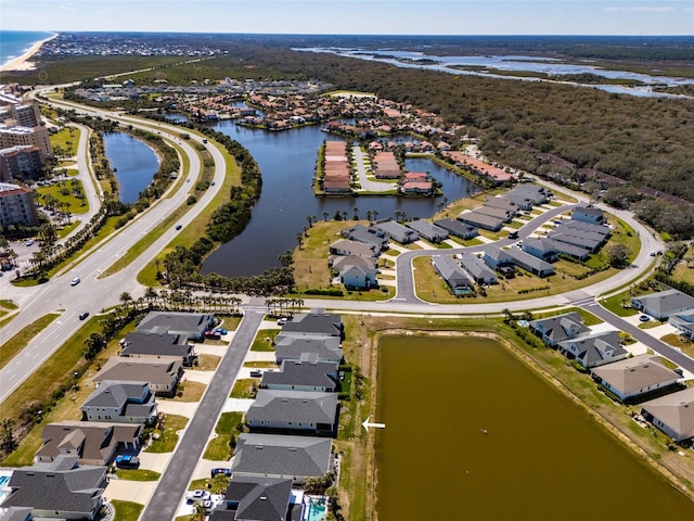 drone / aerial view featuring a water view and a residential view