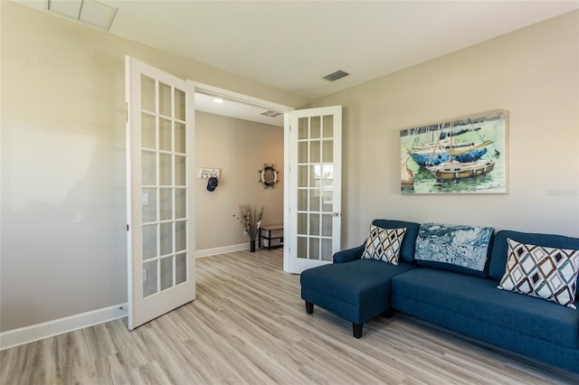 living area featuring visible vents, french doors, baseboards, and light wood-style floors