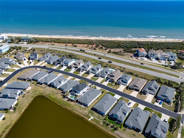 drone / aerial view featuring a residential view and a water view