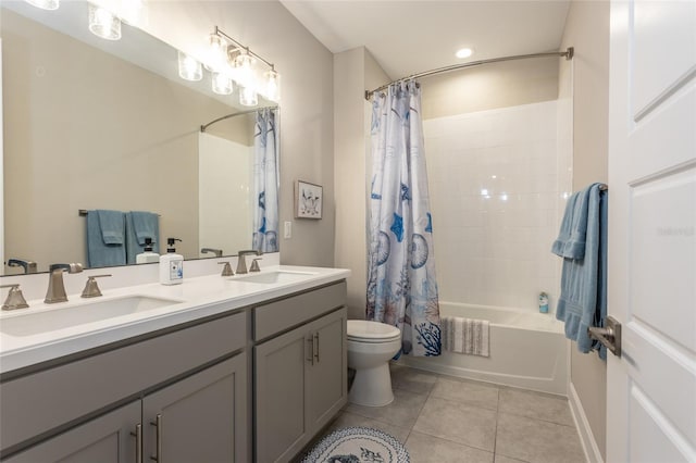 bathroom with tile patterned floors, shower / bath combination with curtain, toilet, and a sink