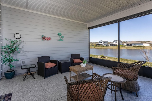 sunroom / solarium with a water view