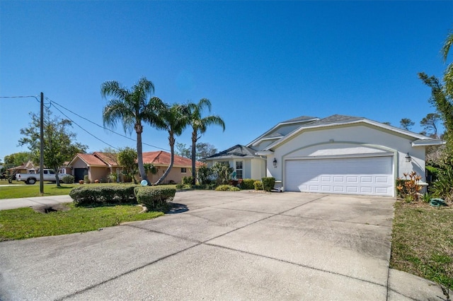 single story home with a garage, driveway, and stucco siding