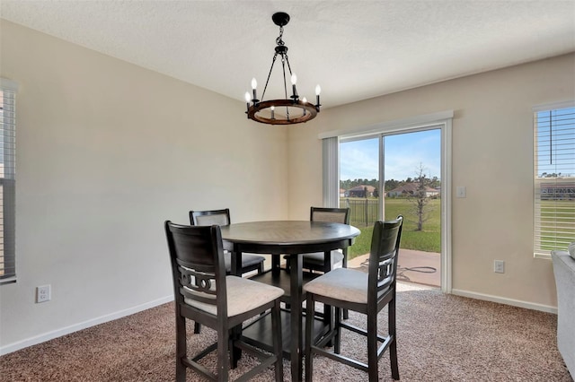 dining room with baseboards, light colored carpet, a chandelier, and a textured ceiling