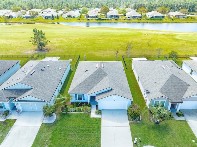 drone / aerial view featuring a water view and a residential view