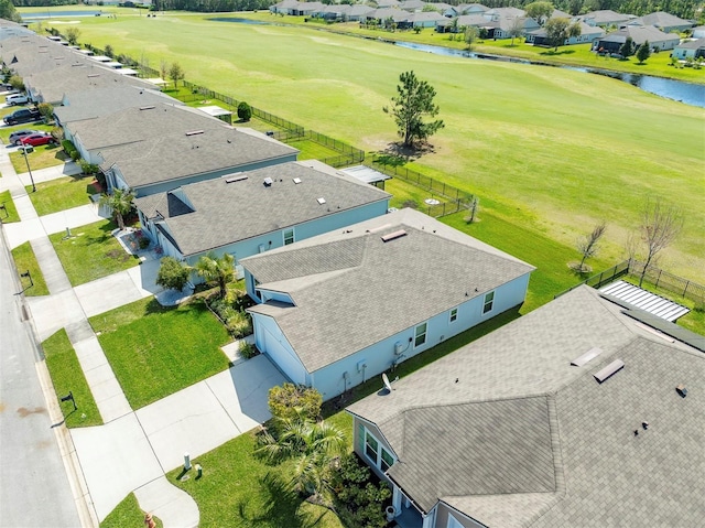 bird's eye view with golf course view, a water view, and a residential view