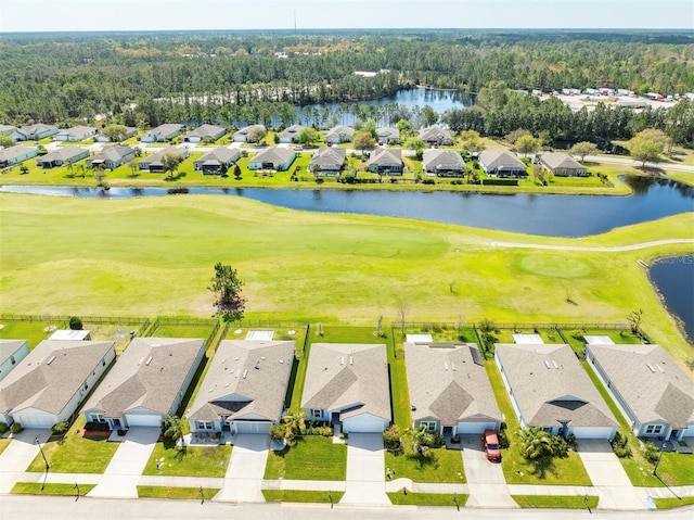 drone / aerial view featuring a residential view, a water view, and view of golf course