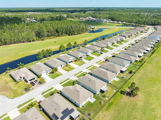 aerial view featuring a residential view, a view of trees, a water view, and view of golf course