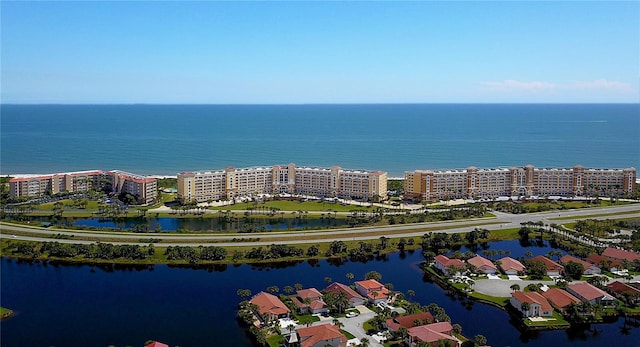 birds eye view of property with a view of city and a water view