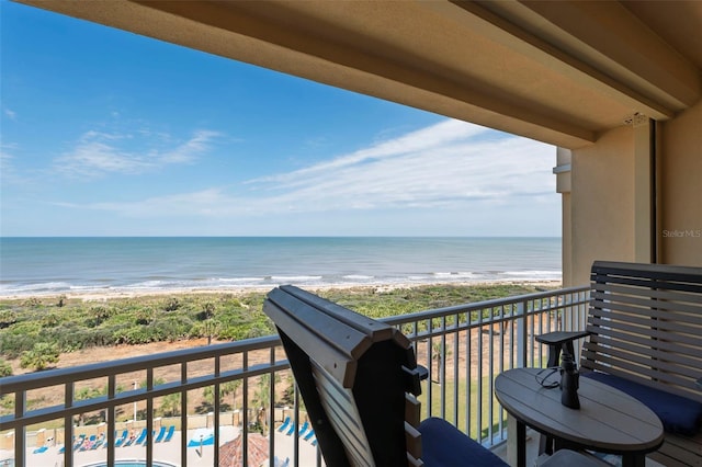 balcony featuring a beach view and a water view