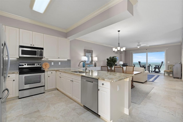 kitchen featuring ornamental molding, a sink, light stone counters, stainless steel appliances, and a peninsula