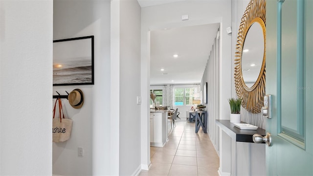 hall featuring light tile patterned flooring and recessed lighting