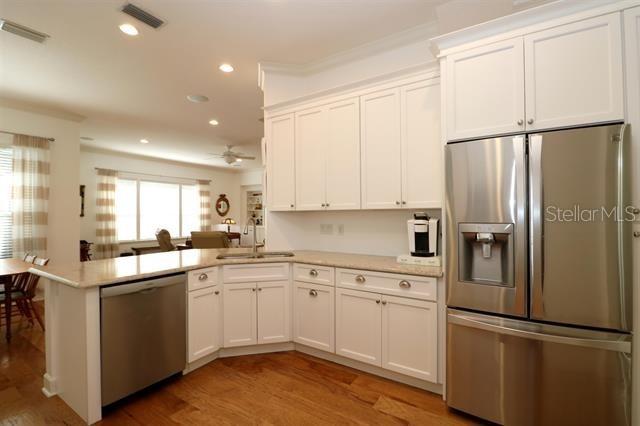 kitchen with visible vents, light countertops, a peninsula, stainless steel appliances, and a sink