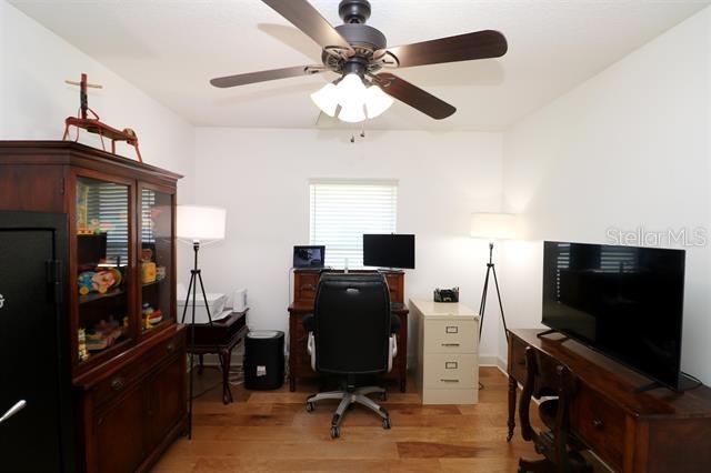 office space featuring a ceiling fan and light wood finished floors