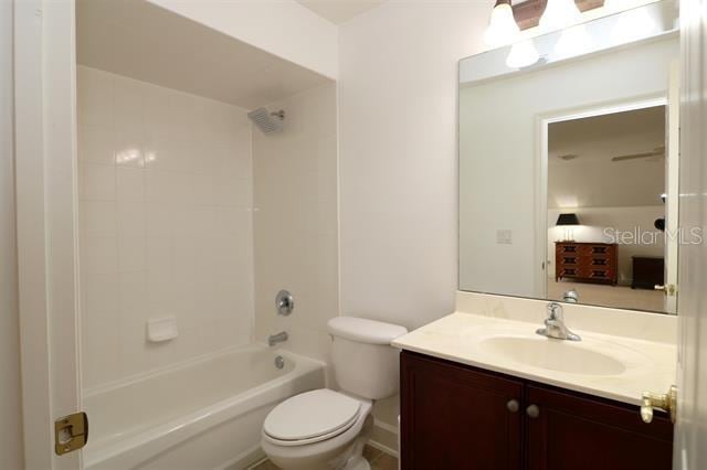 bathroom with shower / tub combination, toilet, and vanity