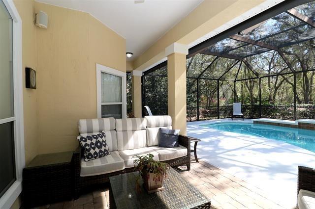 pool with an outdoor hangout area, a lanai, and a patio area