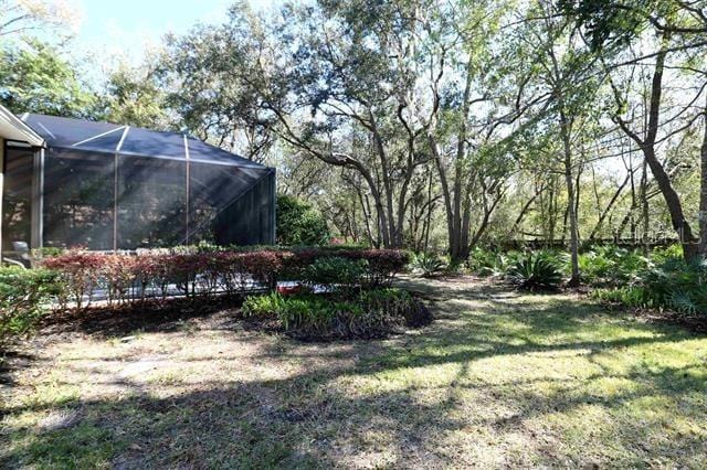 view of yard featuring glass enclosure