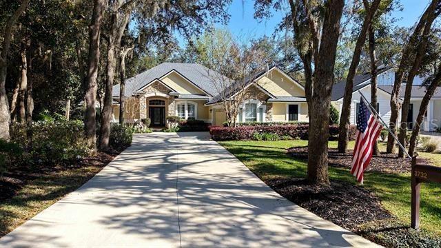 view of front of property with concrete driveway and a front lawn