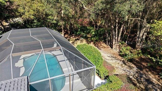 view of swimming pool featuring a lanai