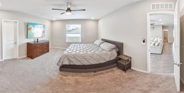 bedroom featuring recessed lighting, light colored carpet, visible vents, and baseboards