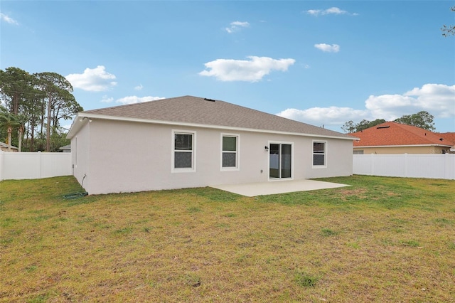 back of property with a patio, a lawn, a fenced backyard, and stucco siding