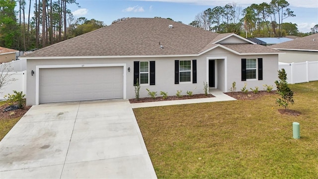 ranch-style home featuring a front lawn, fence, concrete driveway, a shingled roof, and a garage