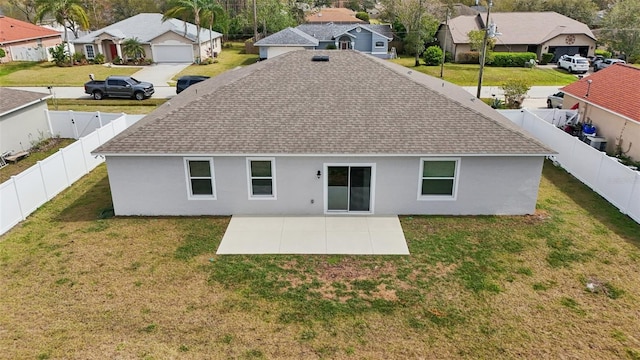 back of house with a patio, a fenced backyard, stucco siding, a lawn, and a residential view