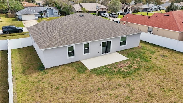 rear view of house with a yard, a patio area, a residential view, and roof with shingles