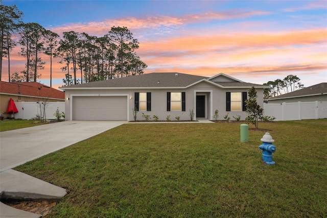 ranch-style house featuring an attached garage, a front lawn, fence, stucco siding, and driveway