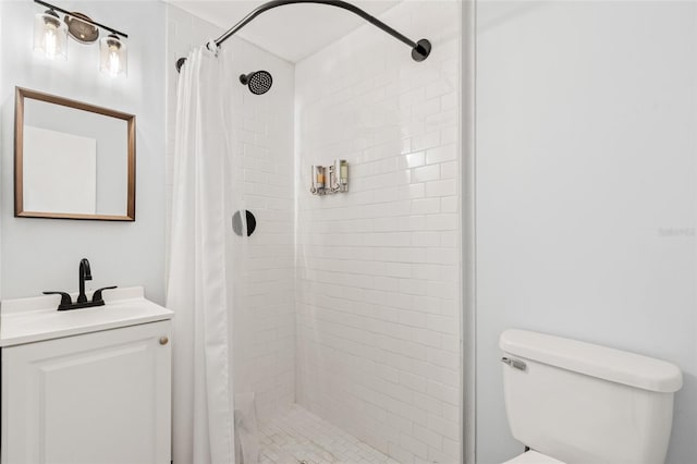 bathroom with vanity, toilet, and a shower stall