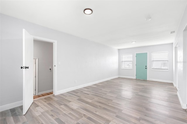 unfurnished room with visible vents, baseboards, and light wood finished floors