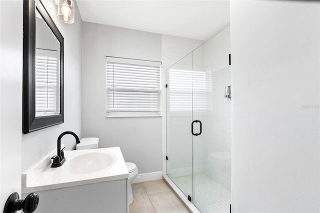 full bathroom featuring toilet, a shower stall, tile patterned flooring, baseboards, and vanity